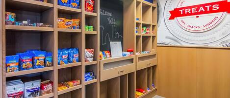 A snack display with various brands like Chex Mix, Doritos, and Lay's.