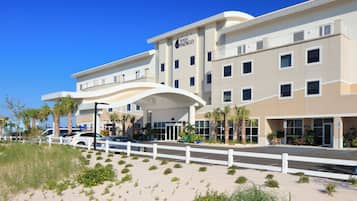 A hotel with a modern design, featuring a prominent entrance and multiple windows.
