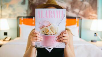A person holding a magazine with a dessert on the cover.
