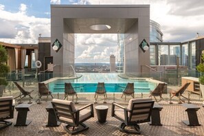 A rooftop pool area with lounge chairs and a view of the cityscape. - The Westin Nashville (Nashville)
