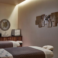 Two beds with matching headboards and a small kitchenette make this room a convenient retreat.