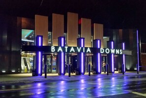 The entrance to Batavia Downs with illuminated signage and a modern architectural design. - Hotel At Batavia Downs (Batavia)