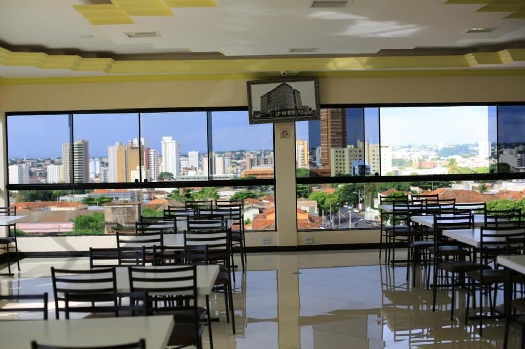 A spacious dining area with large windows offering a city view.