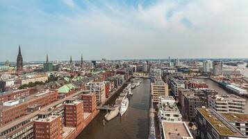 A cityscape with a river, historic buildings, and modern architecture.