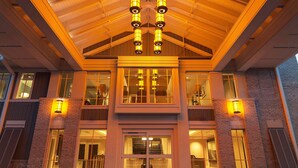 A two-story building with a prominent entrance, large windows, and a distinctive roof design.