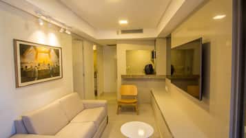 Luxury Studio Suite, 1 Bedroom, Lanai | Living area | 32-inch flat-screen TV with cable channels, TV