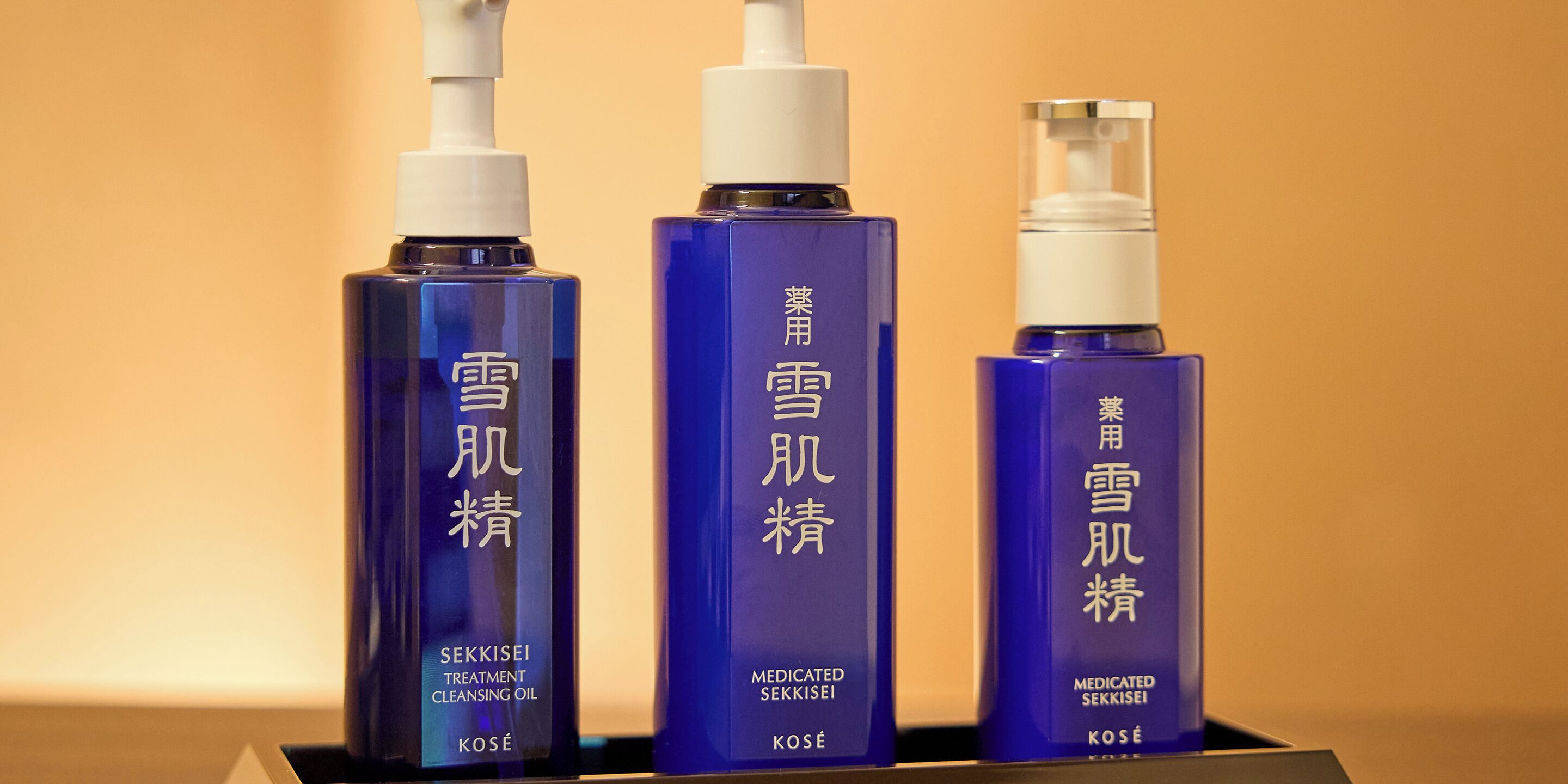 Three bottles of skincare products with Asian characters and English text.