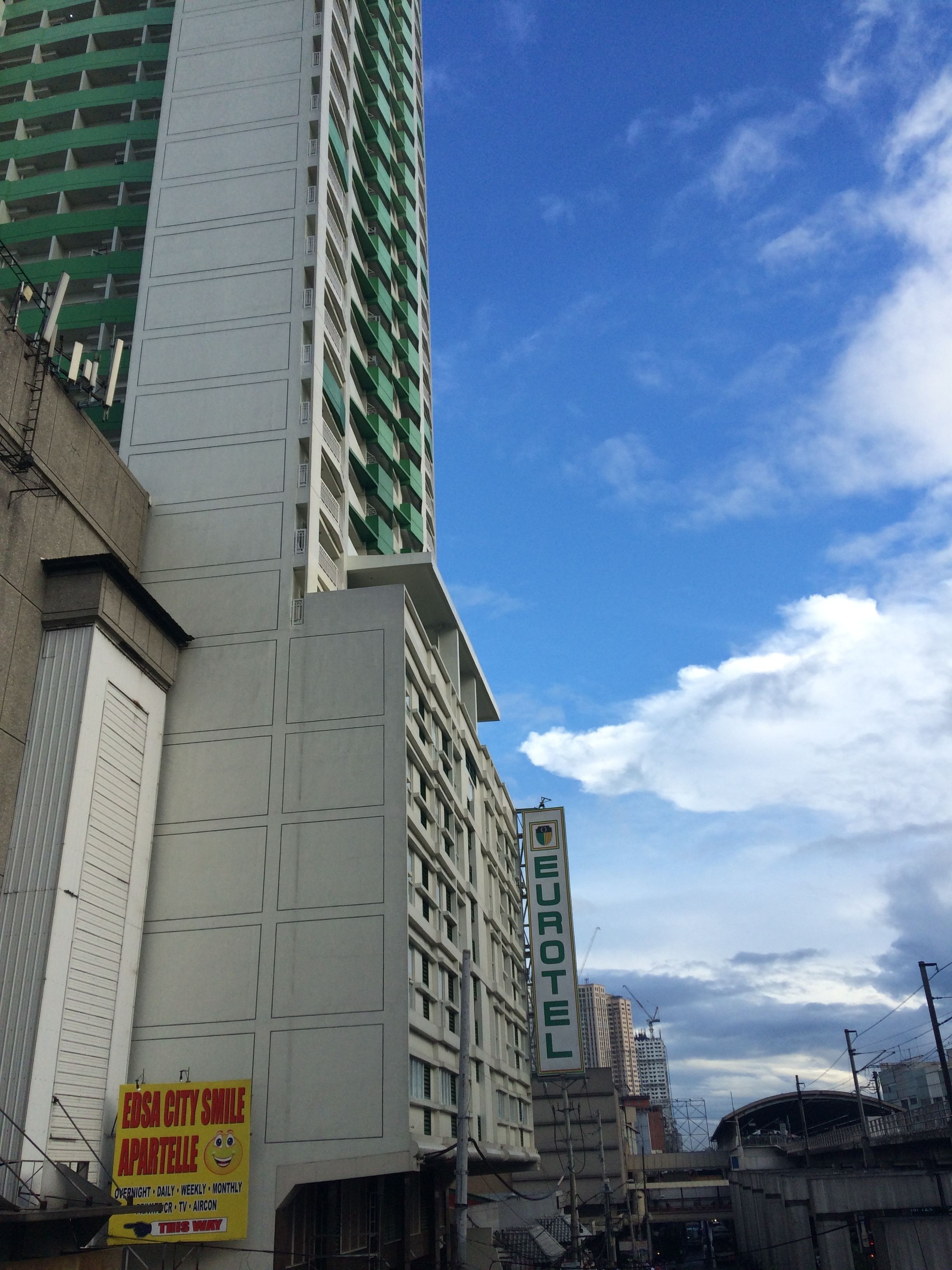 A multi-story building with a sign for the Eurotel Hotel.