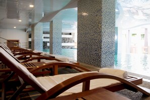 A poolside area with lounge chairs and a view of the pool. - Eastern Palace Hotel (Mandalay)