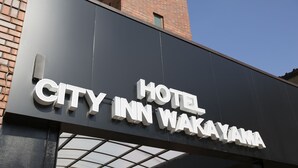 A hotel sign with the name "CITY INN WAKAYAMA".