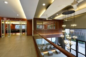 A modern interior with a staircase, a dining area, and a view of the outdoors. - Hisea Huahin Hotel (Hua Hin)