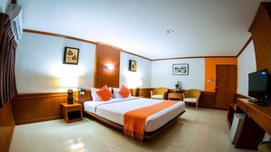 A hotel room with a bed, bedside tables, a desk, a chair, and a television. - Siam Boutique (Buriram)