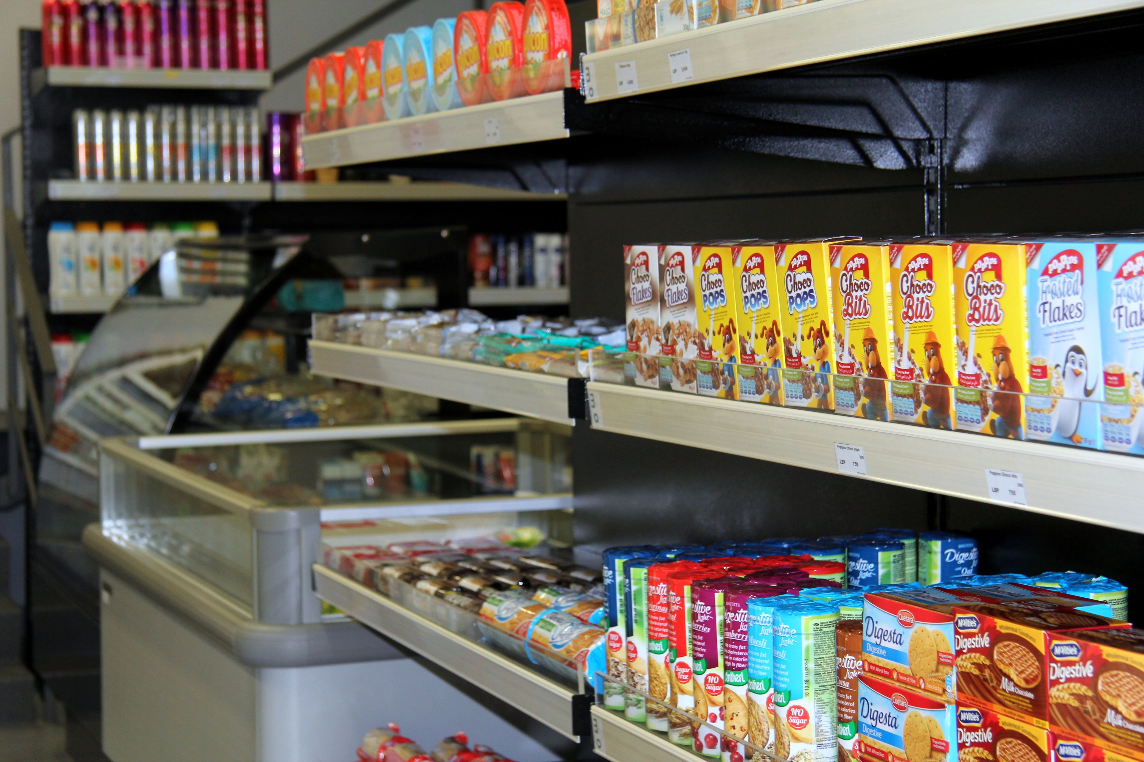 Shelves stocked with various food products including cereals, snacks, and dairy items.