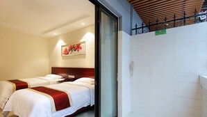 A hotel room with two beds, a wooden ceiling, a wall-mounted phone, and a decorative painting. - Nan Fang Da Sha Hotel (Guangzhou)