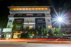 A multi-story hotel with a modern design, featuring balconies on the upper floors and a well-lit facade. - Hotel Shompen (Port Blair)