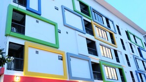 Un immeuble à plusieurs étages, doté d’une architecture moderne, avec des balcons et de grandes fenêtres.