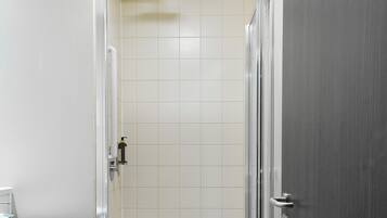 A bathroom with a shower, toilet, and sink.