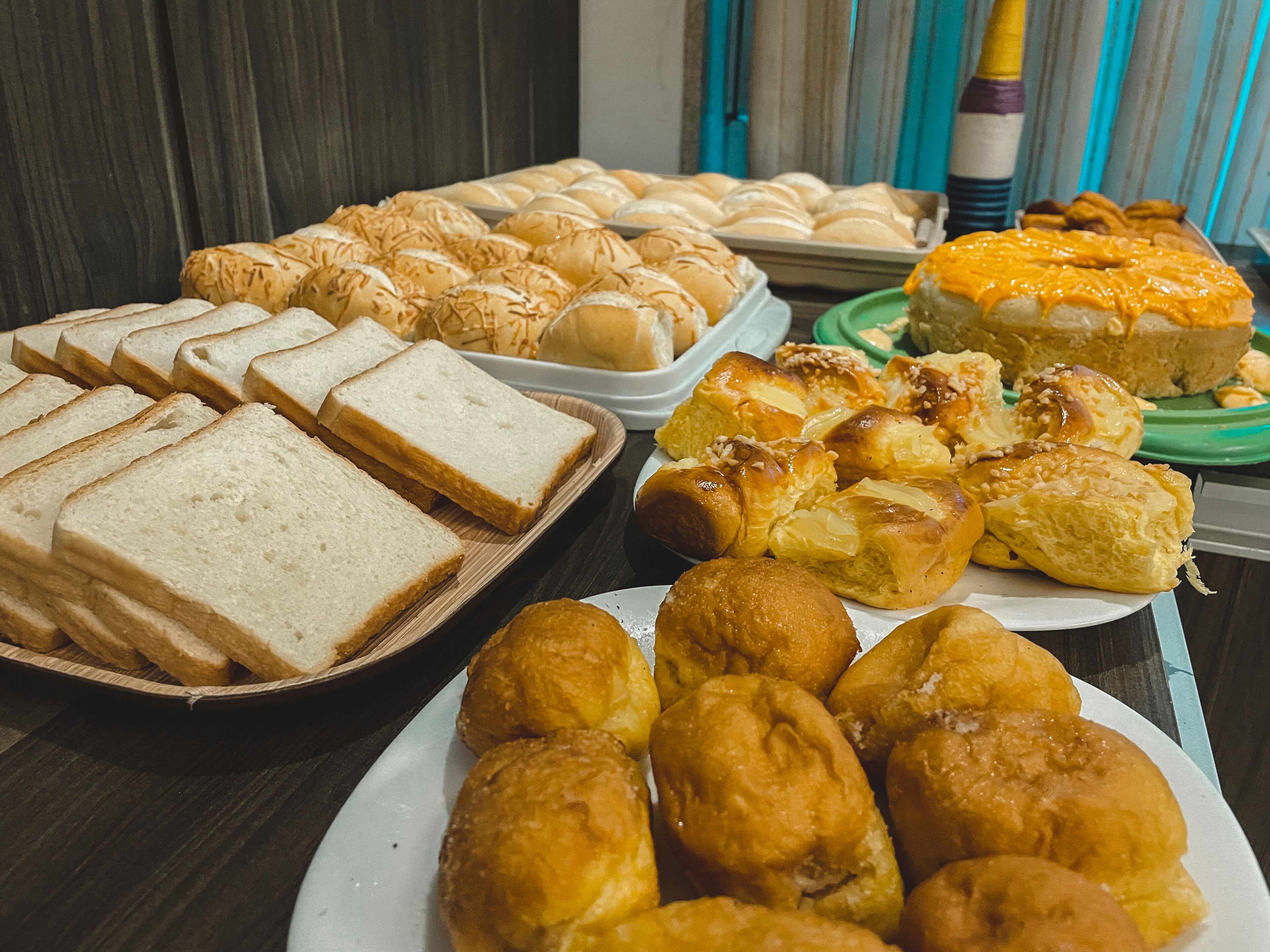 A variety of baked goods including bread, rolls, and pastries on a table.
