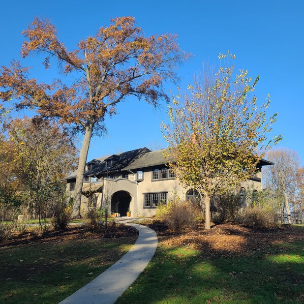 A large, two-story building with a prominent entrance and a covered walkway leading to the main entrance.