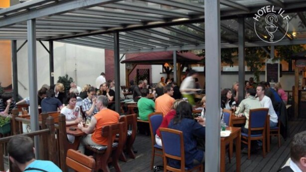 A restaurant with outdoor seating, covered by a metal roof, and a sign reading "HOTEL IFL". - ILF Hotel Prague (Prague)