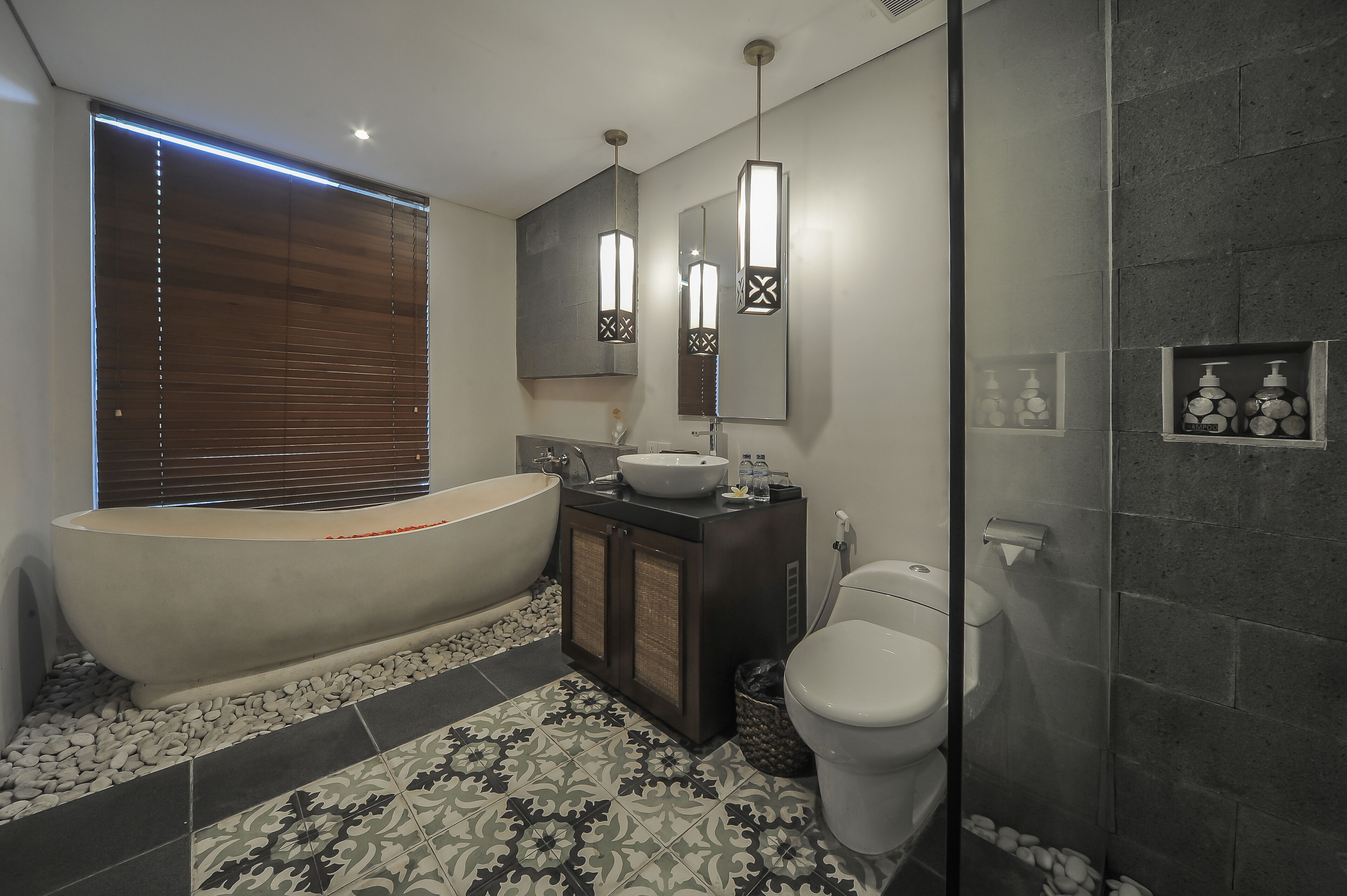 A modern bathroom with a freestanding bathtub, a large mirror, and a shower area.