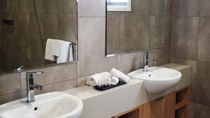 A modern bathroom with two sinks, a large mirror, and a window. - Euston Motel (Euston)