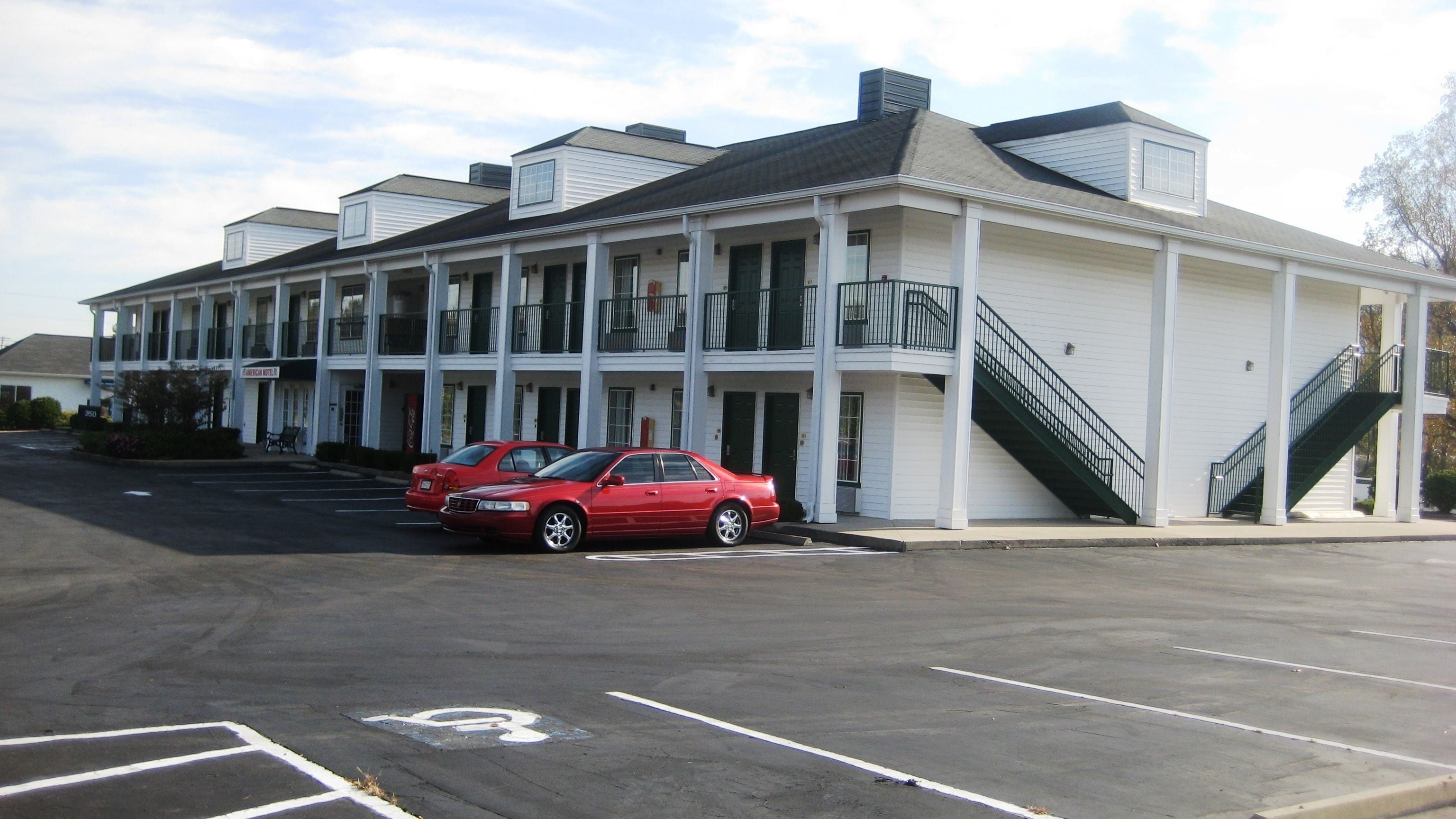 A two-story motel with a covered parking area.