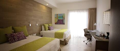A hotel room with two beds, a desk, and a chair.
