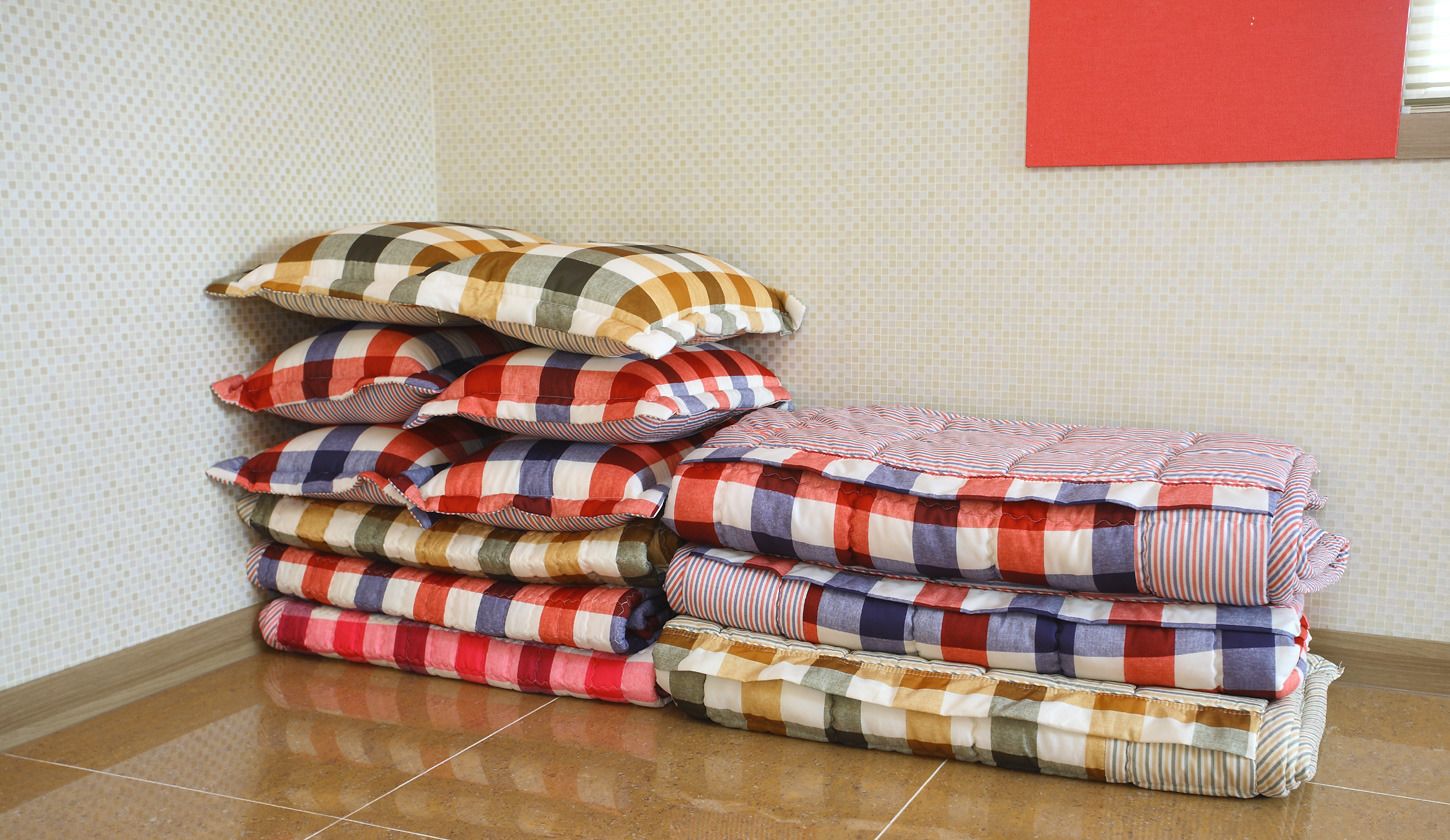 A stack of folded blankets with checkered patterns in various colors.