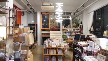 A bookstore with shelves of books, a coffee machine, and a variety of items on display.