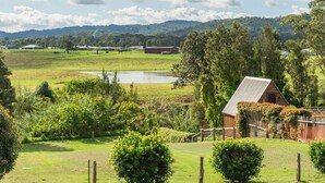 A rural landscape with a barn, a pond, and a fenced pasture. - Kings and Queens Paterson (Paterson)