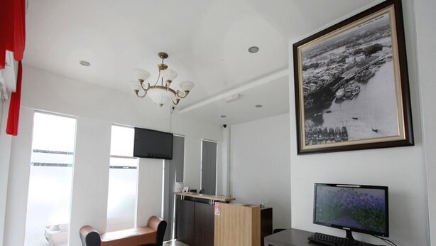 A modern room with a desk, computer, and a large framed photo on the wall.