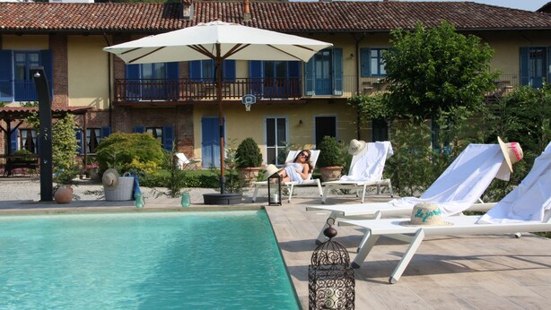 Un espace piscine agrémenté de chaises longues et d’une lanterne décorative.