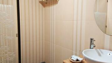 A bathroom with striped walls, a white sink, a mirror, and a towel rack.