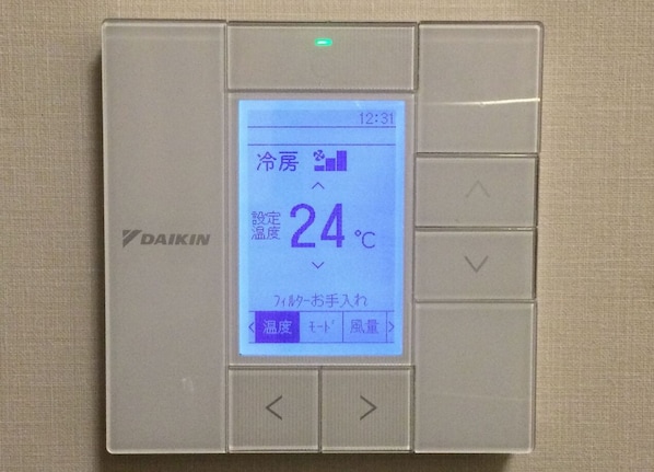 A digital thermostat with a display showing a temperature of 24°C.