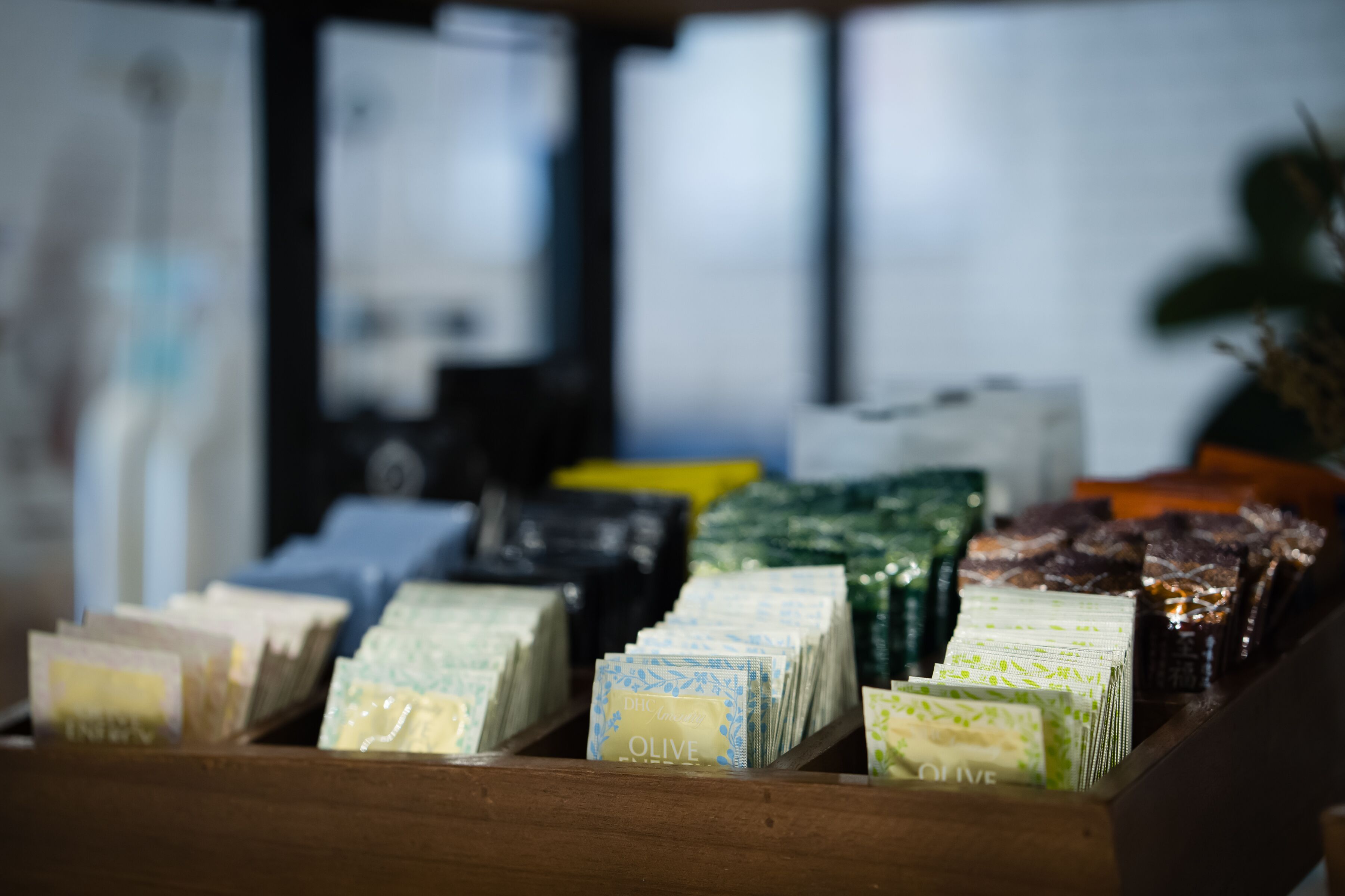 A display of various packaged goods, including items labeled "OLIVE" and "Cinnamon."