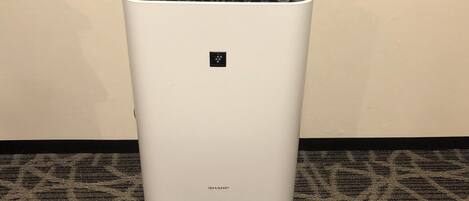 A white, modern air conditioning unit with a control panel on top and the brand name 'SHARP' at the bottom.