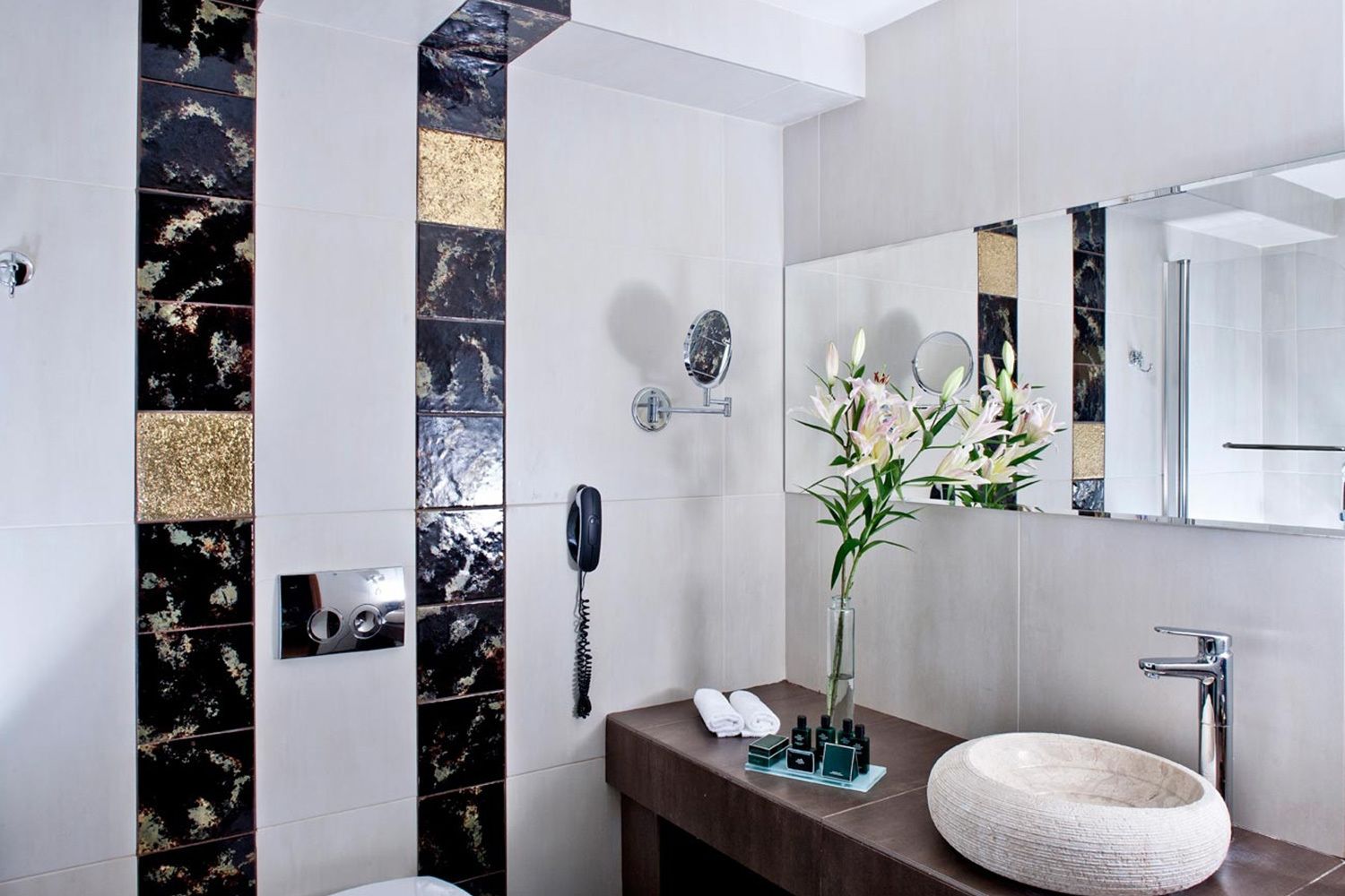 designer toiletries, hair dryer, slippers, towels