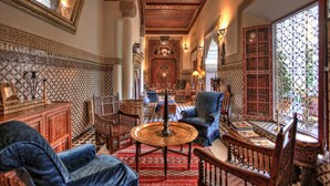 A traditional Moroccan interior with ornate tile work, a central coffee table, and seating arrangements. - Riad Kaiss by Anika (Marrakech)