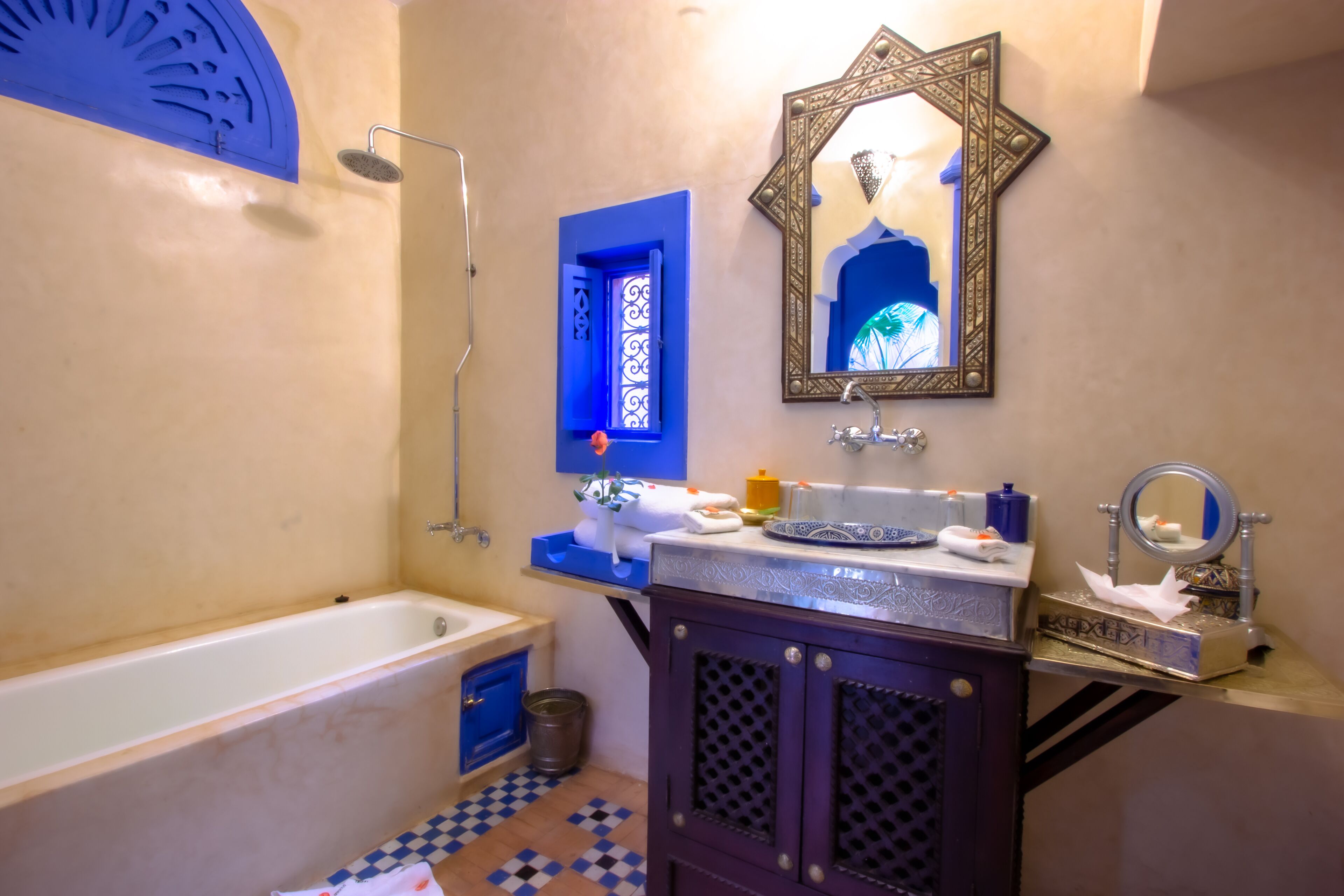 A bathroom with a bathtub, a sink with a mirror, and a shower.