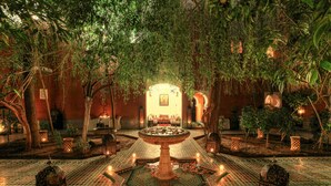 A courtyard with a central fountain, surrounded by lanterns and potted plants, with a tiled floor and a warm, inviting atmosphere. - Riad Kaiss by Anika (Marrakech)
