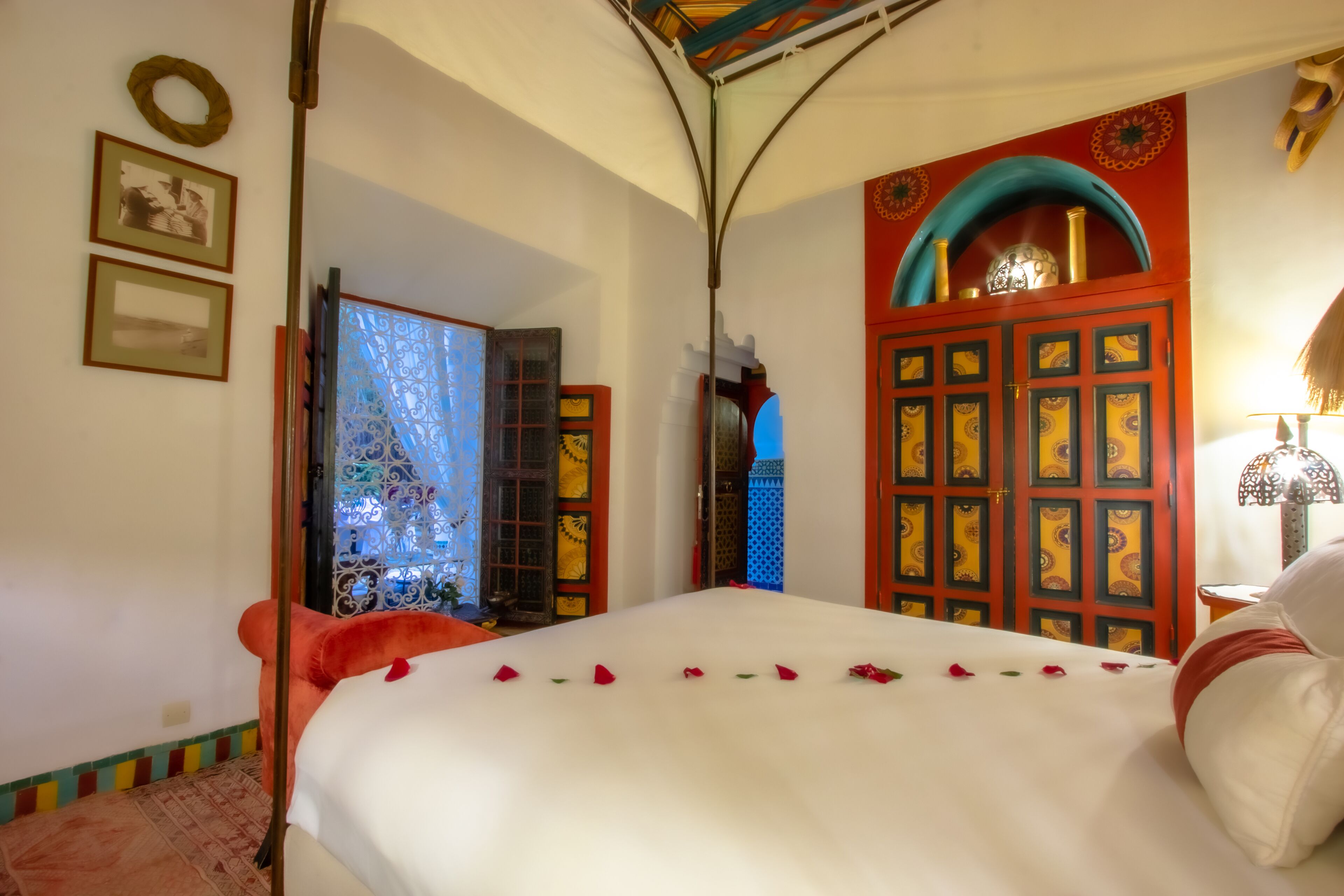 A bedroom with a bed, a wardrobe, and a door with decorative panels.