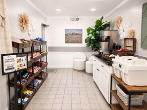A clean, well-organized kitchen with a coffee machine, storage bins, and a 'Forgot Something?' sign.