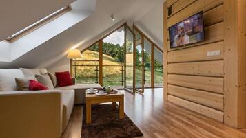 Deluxe Apartment, Balcony, Mountain View | Living area | Flat-screen TV