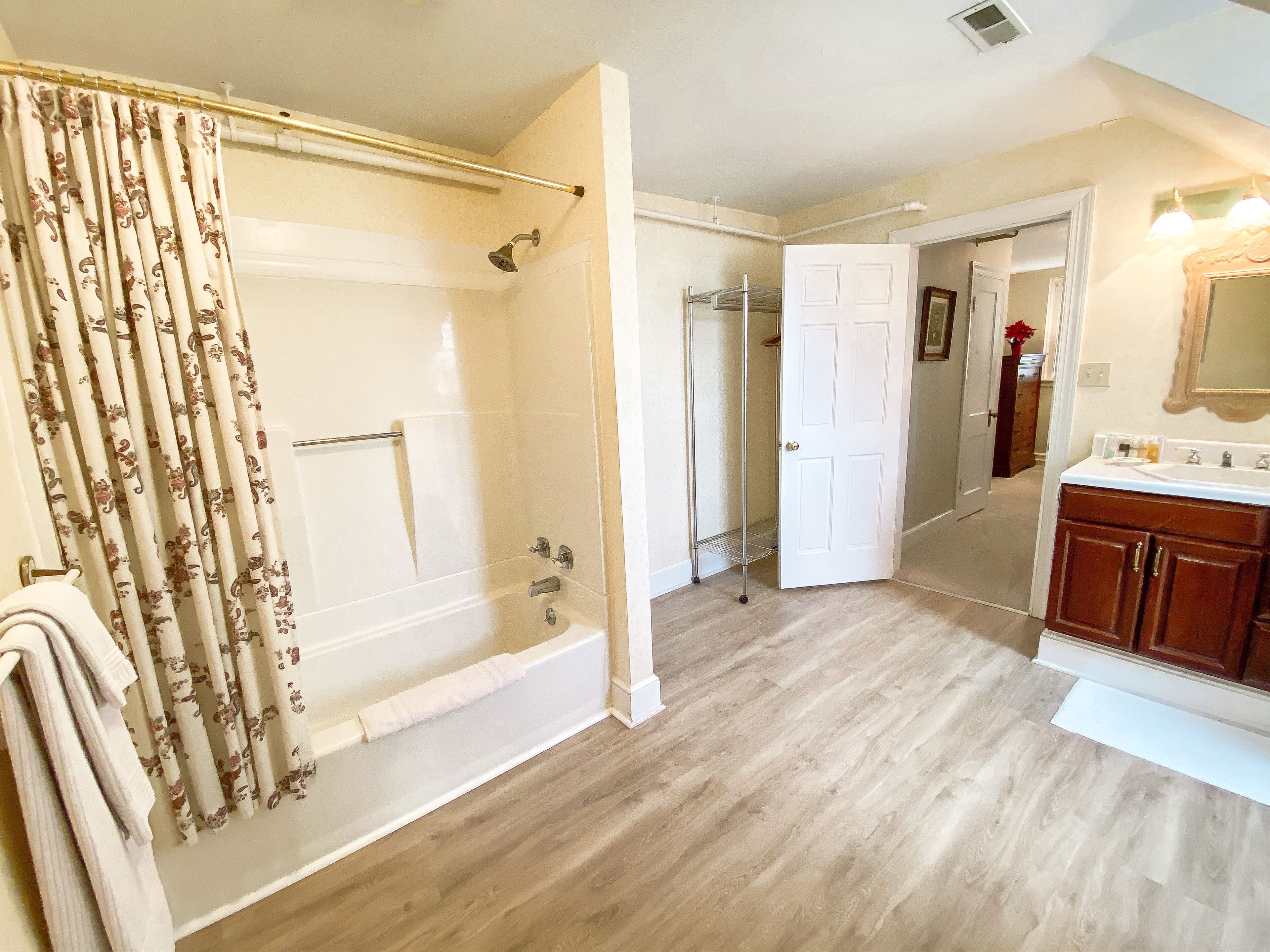 A bathroom with a shower, toilet, and sink.