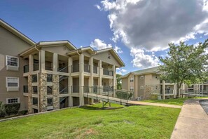 A multi-story residential building with a central courtyard, balconies, and a covered walkway.