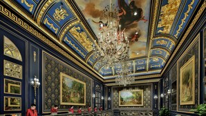 A grand room with ornate blue and gold decorations, a large chandelier, and several paintings. - The Parisian Macao (Cotai)