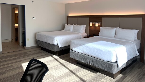 A hotel room with two beds, a wooden headboard, a nightstand, and a chair. - Holiday Inn Express & Suites Danville by IHG (Danville)