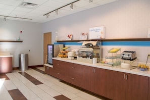 A breakfast bar with a coffee machine, toaster, and fruit display. - Holiday Inn Express & Suites Danville by IHG (Danville)