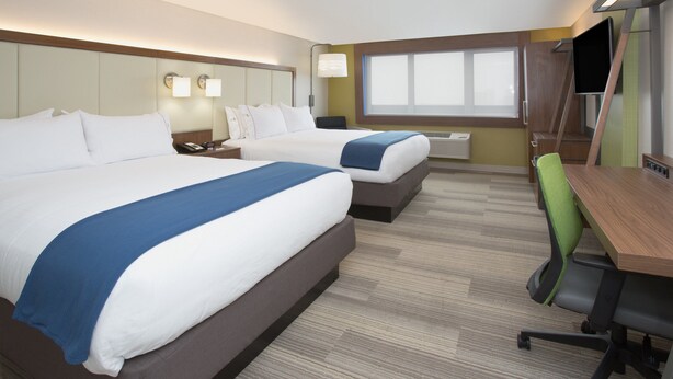 A hotel room with two beds, a desk, a chair, a TV, and a window. - Holiday Inn Express & Suites Perryton by IHG (Perryton)